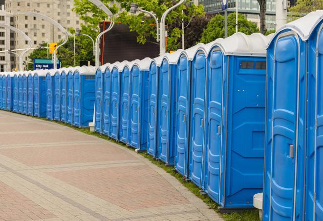 a row of portable restrooms set up for a large athletic event, allowing participants and spectators to easily take care of their needs in Niceville